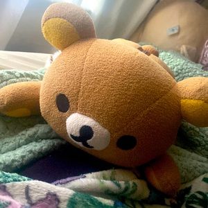 Rilakkuma plushie with a zipper and a fuzzy sensory toy